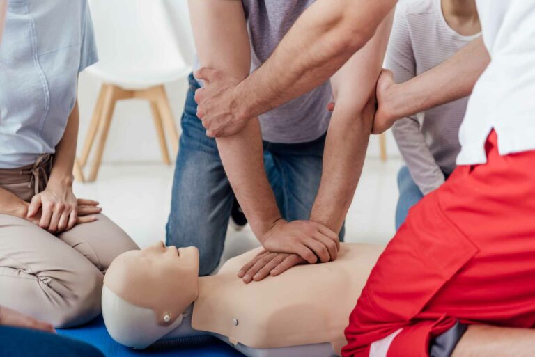 cropped-view-group-people-during-first-aid-training-with-dummy
